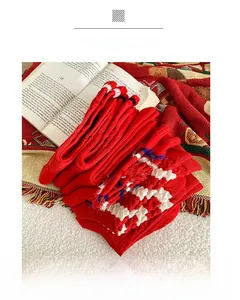 Close-up of red cotton crew socks with white diamond knit pattern and rib details