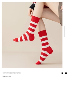 Detail of red and white striped cotton crew socks with classic cable knit texture