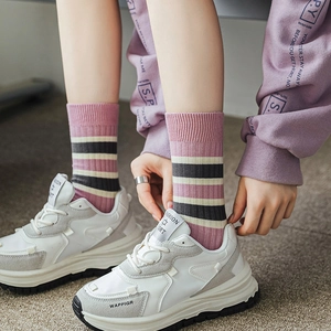 Pink striped cotton crew socks for women styled with chunky white retro sneakers