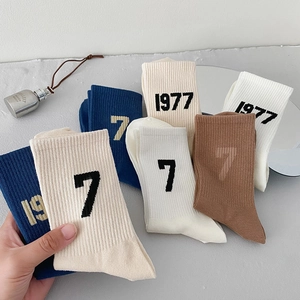 Rib-knit athletic crew socks with 1977 print in navy, cream, white and brown colors