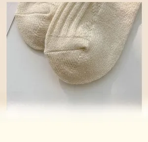 Detailed close-up of thick knitted wool socks with reinforced toe and ribbed texture