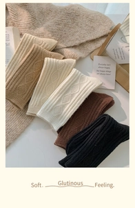 Detailed view of winter cable knit socks in earthy tones showing soft texture and patterns