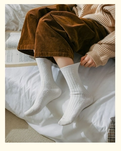 Close-up of white ribbed knit wool socks with a thick texture for winter warmth