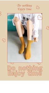 Detailed view of ginger yellow ribbed cotton mid-tube socks worn with casual outfit