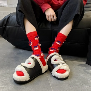 Chic black faux leather plush sandals with white faux fur lining and red fringe socks