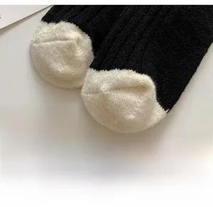 Close-up of contrast toe design on knit wool socks featuring seamless and reinforced stitching