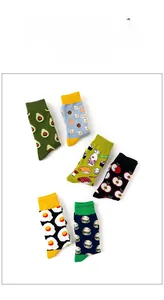 Flat lay of six pairs of cotton crew socks featuring colorful cartoon food patterns