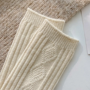 Creamy wool argyle cable knit socks with ribbed texture for winter warmth