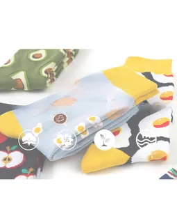 Detail of soft combed cotton socks featuring various cartoon fruit and egg patterns