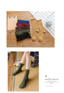 Close-up of women's ribbed crew socks with lettuce trim edges in various vintage colors