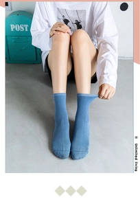 Detailed texture of Morandi blue ribbed cotton socks shown on model in minimalist setting