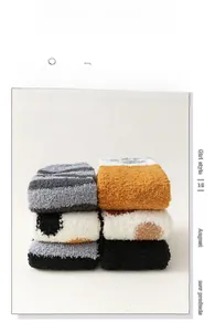 Detail of six assorted coral fleece cat claw socks with thick plush textures and patterns