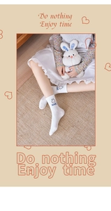 Detail view of white cotton mid-calf sock with sweet bunny embroidery and text