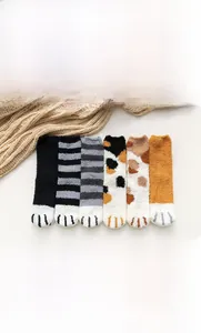 Close-up of cat paw coral fleece socks in six patterns with soft high cotton texture