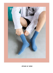 Detail of blue cotton mid-calf socks with classic ribbed cuffs and knitted texture