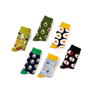 Flat lay of six cotton socks with colorful cartoon food patterns like avocado and sushi