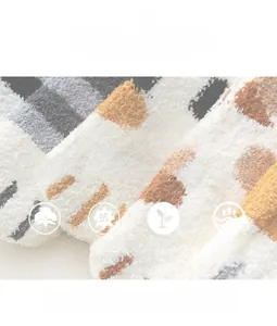 Close-up of thick coral fleece fabric with striped texture and soft plush surface