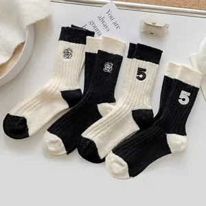 Women's warm wool socks featuring camellia embroidery and contrast color block design