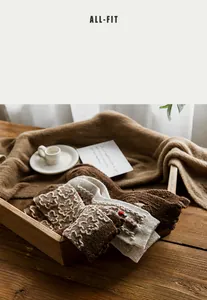 Detailed view of warm wool blend socks with vintage floral patterns on a wooden tray