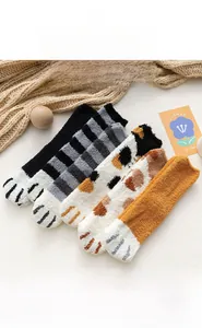 Detailed close-up of four cat paw coral fleece socks in diverse colors and patterns