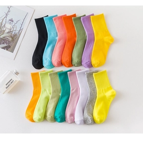 Detailed flat lay of 14 colorful rib-knit crew socks in diverse pastel and bright tones