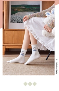 Detail of white cotton calf sock featuring a cute bunny embroidery and sweet text detail