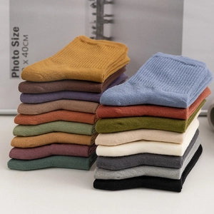 Solid color ribbed cotton crew socks for women in assorted autumn tones and knit texture