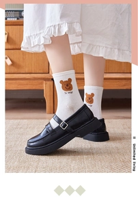 Detail of white cotton crew socks with cute brown bear print and hi bear text embroidery
