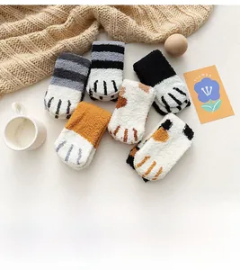 Detail of coral fleece cat claw socks showing soft 3D paw pads in various colors