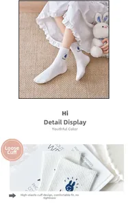 Detailed view of white cotton crew socks with blue bunny embroidery and elastic cuff