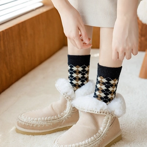 Thick wool socks with leopard pattern and cozy snow boots for winter warmth and comfort
