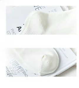 Detailed macro view of reinforced heel and flat toe seams on white cotton bear socks