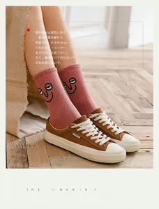 Pink ribbed cotton socks with funny cartoon embroidery styled with brown suede sneakers