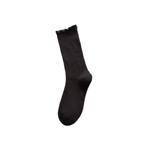 Elegant black mid-calf socks with ruffle trim and vertical ribbed knit texture