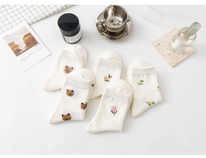 Detail of 5-pack white cotton crew socks with cute bear and floral embroidery