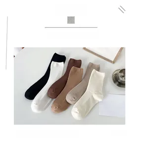 Detailed texture of earth-tone ribbed knit cotton socks in five assorted colors