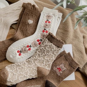 Thick wool blend socks for women featuring cute bear and floral knit patterns in brown
