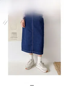 Detail of white cotton crew socks paired with denim skirt and sneakers for casual style