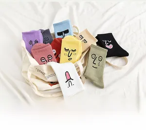Detail of multi-colored cotton crew socks with minimalist cartoon emoji embroidery