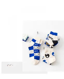 Close-up of cotton socks with checkerboard patterns and heart prints in vibrant blue tones