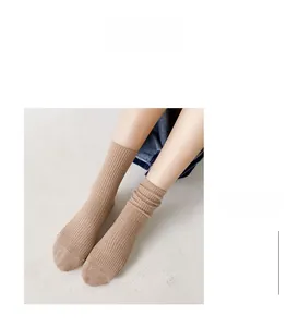 Close-up of khaki ribbed cotton socks styled with blue denim jeans for a casual look