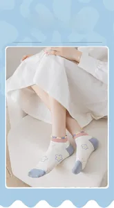 Close-up of sweet ankle socks with colorful star patterns and pink ruffle edge trim