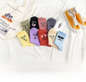 Detail of 10-pack colorful cotton socks featuring various cute cartoon embroidered expressions