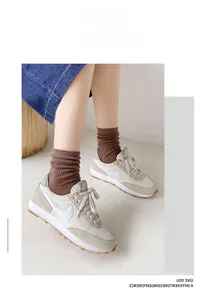Detail of brown cotton crew socks showing ribbed texture paired with sneakers