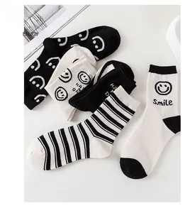 Détail de la broderie visage souriant et des poignets côtelés sur chaussettes mi-hautes