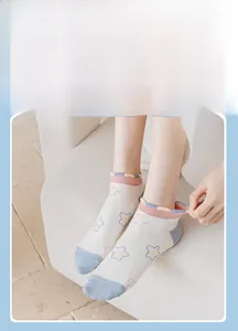 Detail of sweet cotton ankle socks with pink ruffle trim and blue star pattern