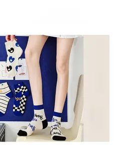 Close-up of cotton mid-calf socks featuring heart patterns and checkerboard designs