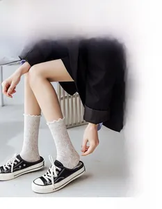 Detail of breathable lace mesh socks with leafy hollow patterns and ruffled cuffs