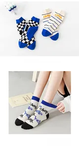 Detail of blue checkerboard and graffiti patterns on cotton mid-calf socks