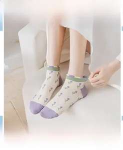 Detailed view of women's jacquard socks with purple floral patterns and lace trim